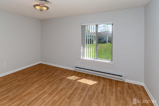 249 Doremus Dr Unit B, Monroe, NJ 08831 - empty room featuring baseboard heating, wood finished floors, and baseboards