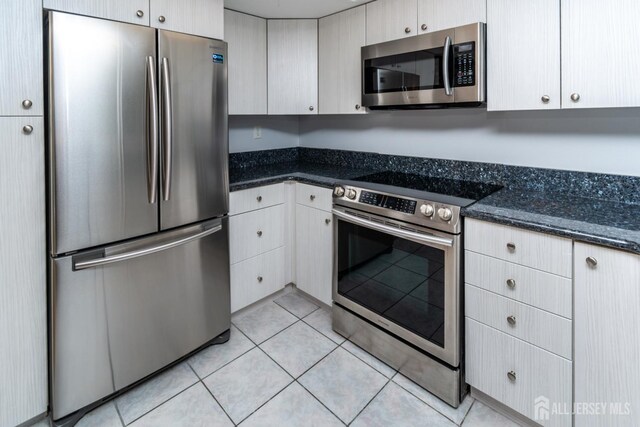 249 Doremus Dr Unit B, Monroe, NJ 08831 - kitchen with appliances with stainless steel finishes, dark stone countertops, and light tile patterned floors