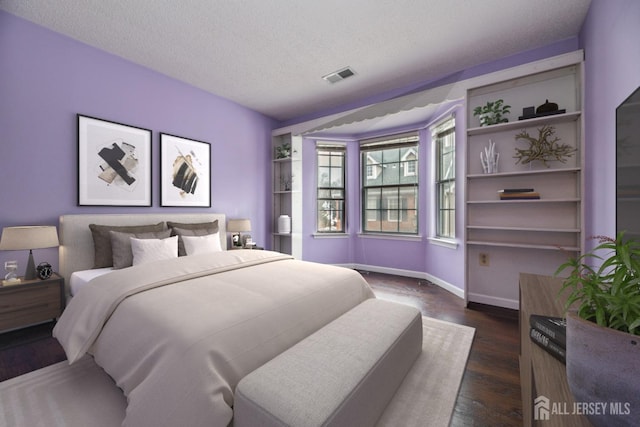 bedroom with visible vents, a textured ceiling, baseboards, and dark wood-style flooring