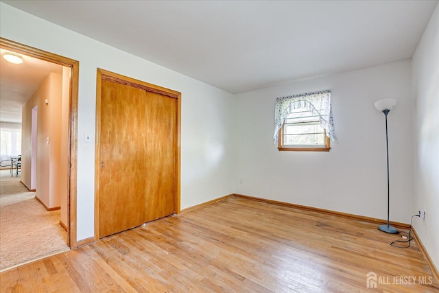 50 Lilac St, Edison, NJ 08817 - unfurnished bedroom with multiple windows, light wood-style flooring, and baseboards