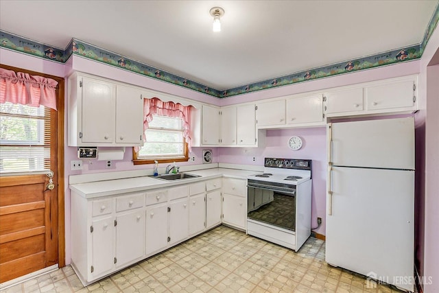 50 Lilac St, Edison, NJ 08817 - kitchen with white appliances, a sink, light countertops, and white cabinetry