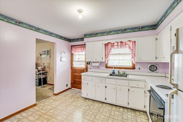50 Lilac St, Edison, NJ 08817 - kitchen with white range with electric stovetop, a sink, baseboards, light countertops, and white cabinets