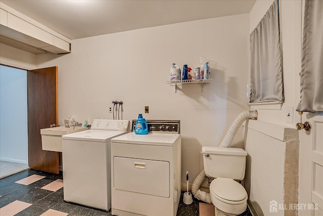 50 Lilac St, Edison, NJ 08817 - laundry room featuring washing machine and clothes dryer, dark flooring, a sink, and baseboards