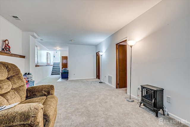 50 Lilac St, Edison, NJ 08817 - living area with a wood stove, light colored carpet, stairway, and baseboards