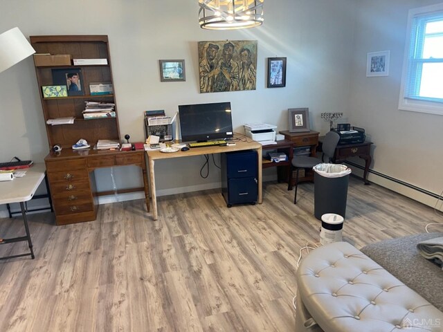 home office featuring baseboard heating, an inviting chandelier, and hardwood / wood-style flooring