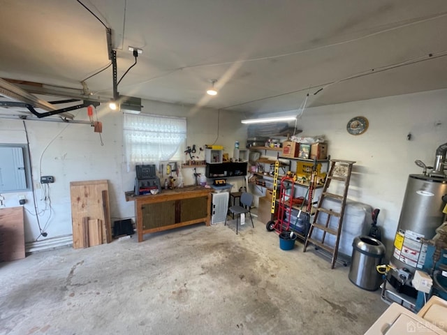 garage featuring a workshop area, gas water heater, and electric panel