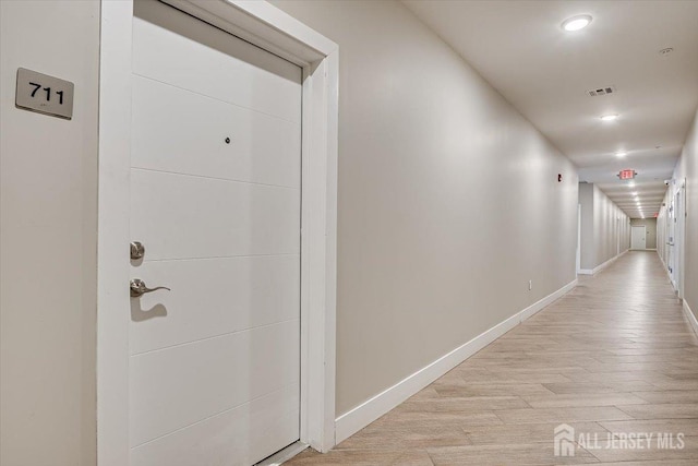 hall with light wood-type flooring