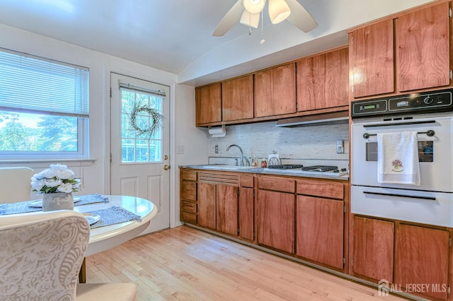 24 Grand Ave, South River, NJ 08882 - kitchen featuring white oven, a warming drawer, a sink, brown cabinetry, and gas stovetop