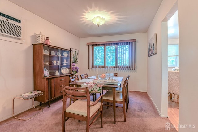 24 Grand Ave, South River, NJ 08882 - dining space with plenty of natural light, light colored carpet, a wall mounted air conditioner, and baseboards