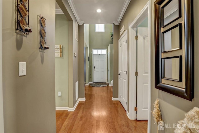 hall with crown molding and light wood-type flooring