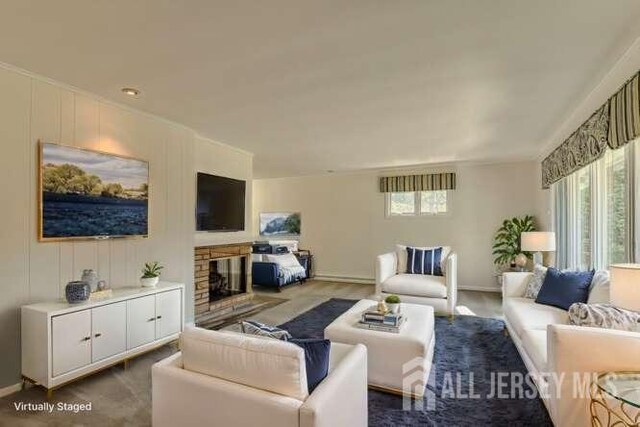 living room with a fireplace and a wealth of natural light