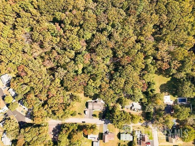 birds eye view of property with a wooded view