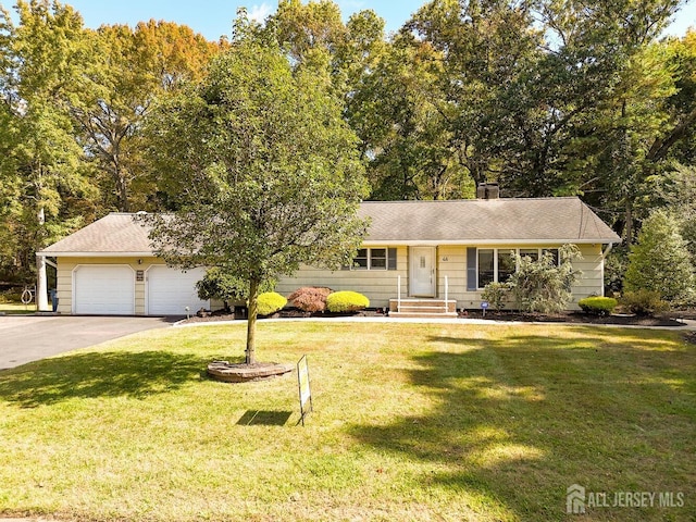 single story home featuring a garage, driveway, and a front lawn