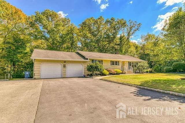 ranch-style house with concrete driveway, a front lawn, and an attached garage