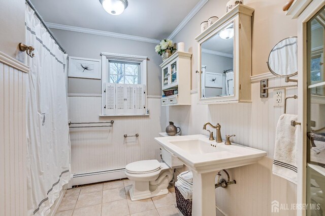 bathroom with tile patterned flooring, ornamental molding, toilet, wood walls, and a baseboard radiator