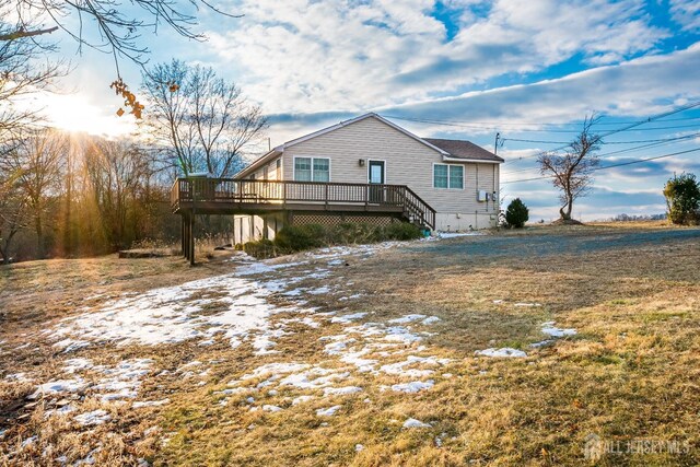 back of house with a wooden deck