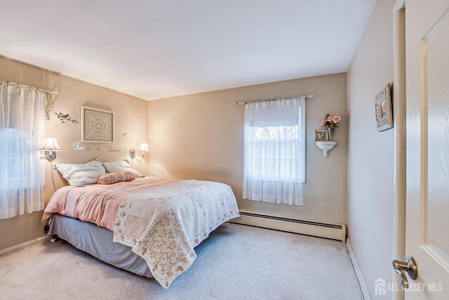 bedroom featuring a baseboard heating unit and light carpet