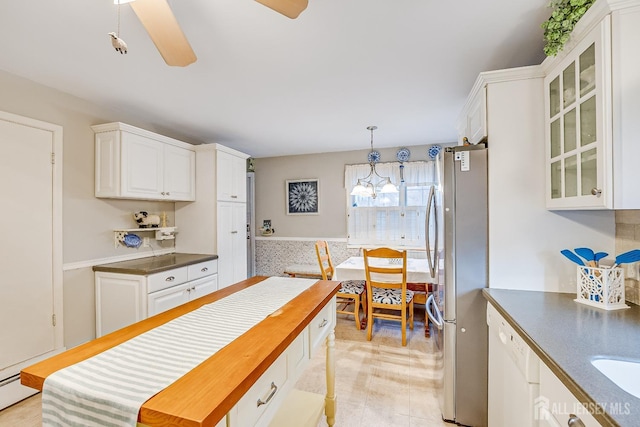 kitchen with dishwasher, a notable chandelier, stainless steel fridge, pendant lighting, and white cabinets