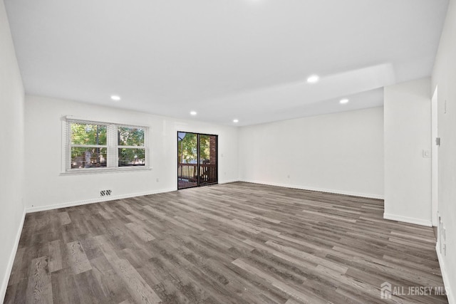 unfurnished living room featuring recessed lighting, baseboards, and wood finished floors