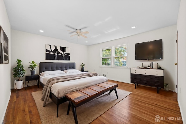 bedroom featuring a ceiling fan, wood finished floors, and recessed lighting