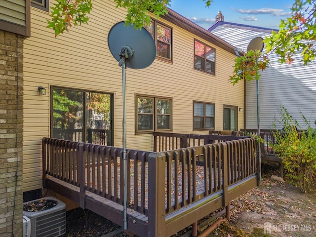 rear view of property featuring a deck and central air condition unit