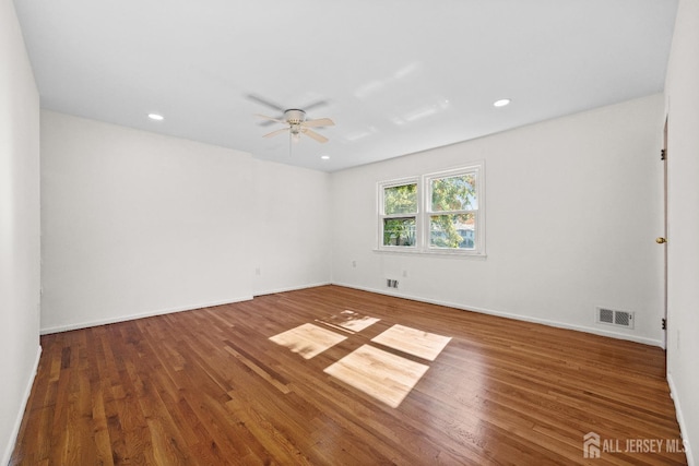 spare room featuring recessed lighting, wood finished floors, visible vents, and a ceiling fan