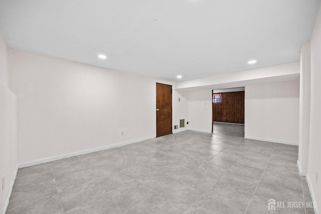 spare room featuring baseboards and recessed lighting