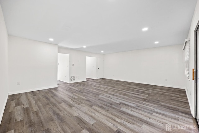 below grade area featuring recessed lighting, baseboards, and wood finished floors