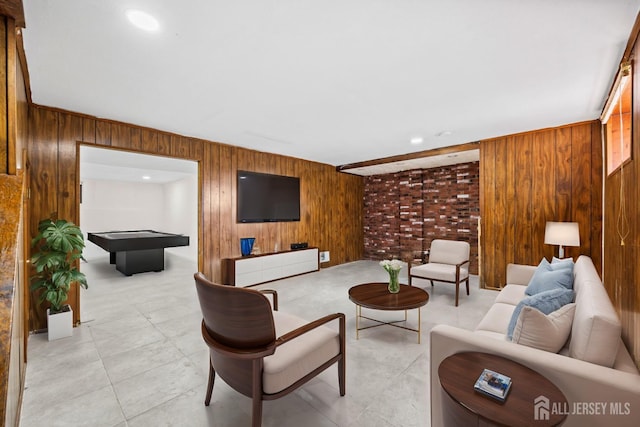 living room featuring wood walls and billiards