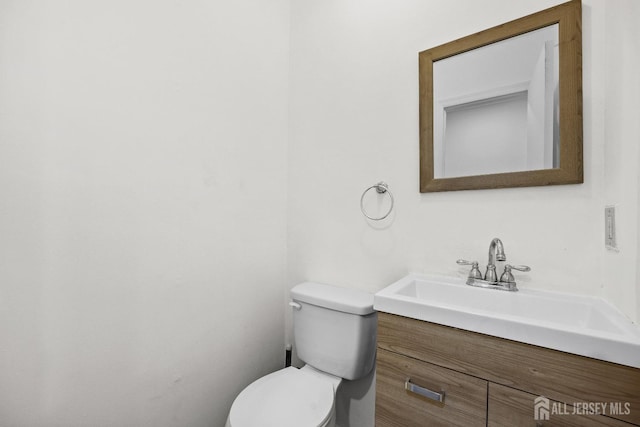 bathroom featuring toilet and vanity