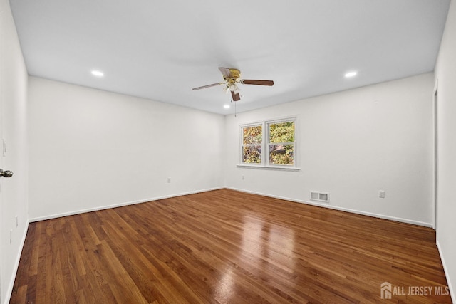 empty room with ceiling fan, visible vents, wood finished floors, and recessed lighting