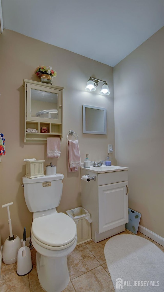 27 Carlton Ave, Monroe, NJ 08831 - half bathroom with toilet, vanity, tile patterned floors, and baseboards
