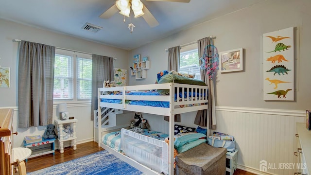 27 Carlton Ave, Monroe, NJ 08831 - bedroom with multiple windows, wainscoting, wood finished floors, and ceiling fan