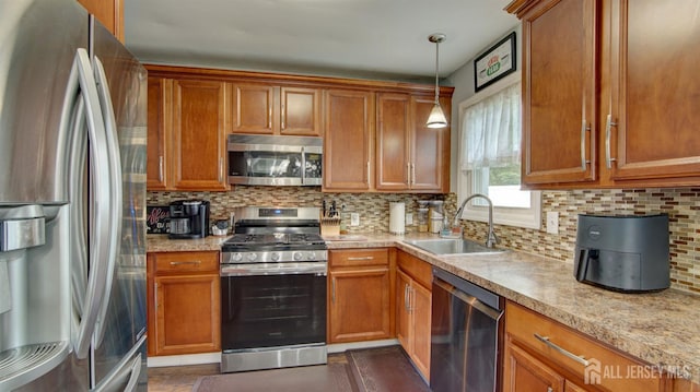 27 Carlton Ave, Monroe, NJ 08831 - kitchen featuring stainless steel appliances, a sink, and brown cabinets