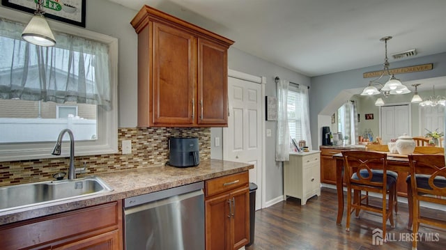 27 Carlton Ave, Monroe, NJ 08831 - kitchen with dishwasher, a sink, brown cabinets, dark wood-style flooring, and backsplash