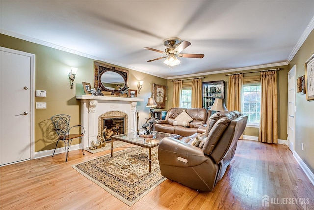 147 Smith St, South Plainfield, NJ 07080 - living room with ceiling fan, light wood-style flooring, a fireplace, crown molding, and baseboards