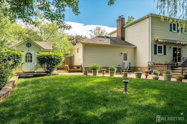 147 Smith St, South Plainfield, NJ 07080 - back of house featuring a chimney and a yard
