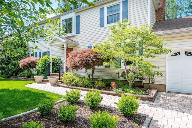 147 Smith St, South Plainfield, NJ 07080 - view of front of home with a front lawn, a chimney, and a garage