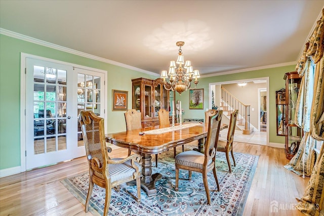 147 Smith St, South Plainfield, NJ 07080 - dining space with a chandelier, stairs, light wood-type flooring, crown molding, and baseboards