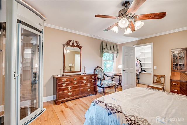 147 Smith St, South Plainfield, NJ 07080 - bedroom with light wood finished floors, ornamental molding, a walk in closet, a ceiling fan, and baseboards
