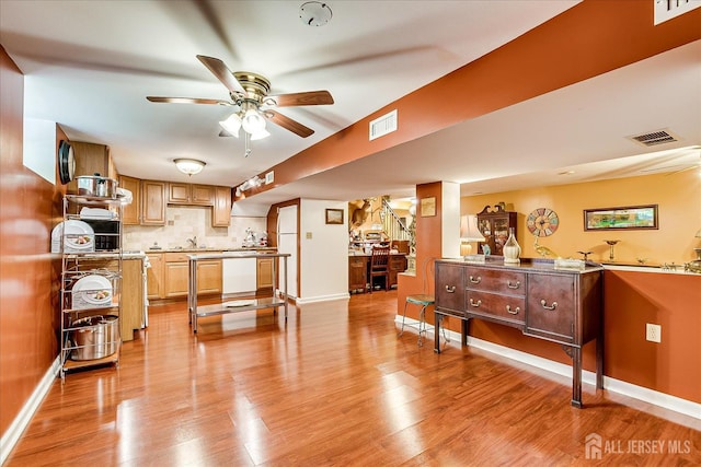 147 Smith St, South Plainfield, NJ 07080 - kitchen featuring a sink, a ceiling fan, light wood-style flooring, tasteful backsplash, and baseboards