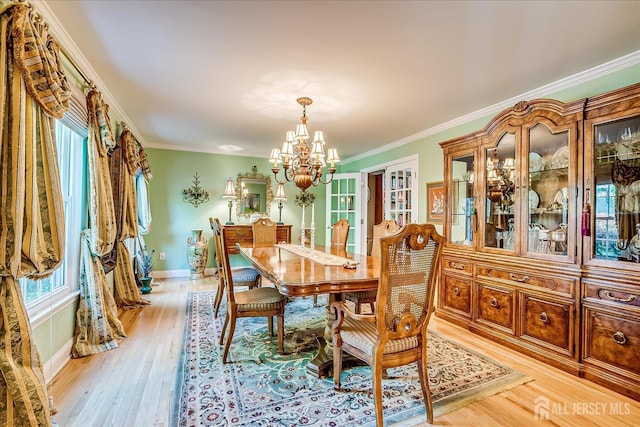 147 Smith St, South Plainfield, NJ 07080 - dining room featuring a chandelier, baseboards, light wood-style flooring, and crown molding