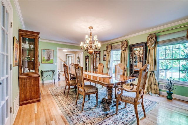 147 Smith St, South Plainfield, NJ 07080 - dining space featuring a chandelier, light wood-style floors, baseboards, and crown molding