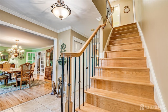 147 Smith St, South Plainfield, NJ 07080 - staircase featuring tile patterned floors, ornamental molding, a chandelier, and baseboards