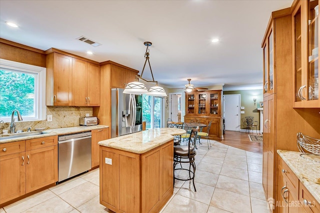 147 Smith St, South Plainfield, NJ 07080 - kitchen with appliances with stainless steel finishes, a sink, tasteful backsplash, a center island, and light stone counters