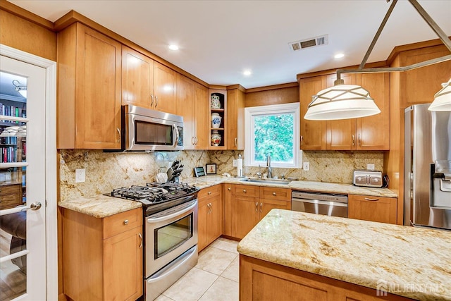147 Smith St, South Plainfield, NJ 07080 - kitchen with appliances with stainless steel finishes, a sink, light stone counters, decorative backsplash, and light tile patterned flooring