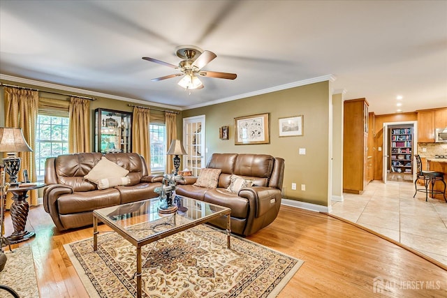 147 Smith St, South Plainfield, NJ 07080 - living room with a ceiling fan, crown molding, baseboards, and light wood finished floors