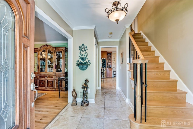 147 Smith St, South Plainfield, NJ 07080 - foyer featuring stairs, baseboards, crown molding, and light tile patterned floors