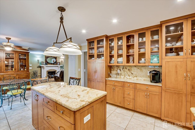147 Smith St, South Plainfield, NJ 07080 - kitchen with light tile patterned flooring, a center island, light stone counters, decorative backsplash, and glass insert cabinets