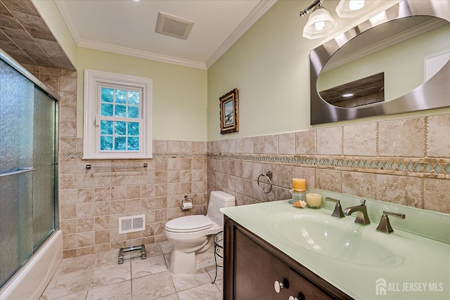 147 Smith St, South Plainfield, NJ 07080 - full bath with tile walls, toilet, vanity, crown molding, and shower / bath combination with glass door